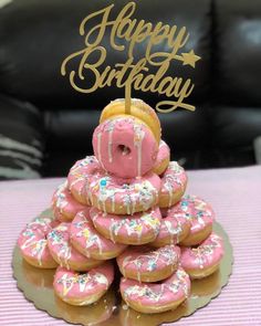 a birthday cake made out of doughnuts with sprinkles on top