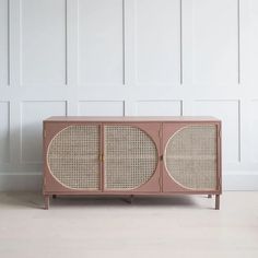 the sideboard is made out of rattan and has two doors on each side