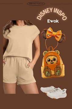 a woman wearing shorts and a top with a bear head on it, next to shoes