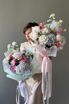 a woman holding a bouquet of flowers in her hands