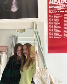 two women are taking a selfie in the mirror