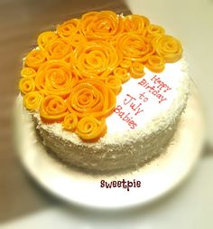 a birthday cake decorated with orange flowers on a white plate that says happy bday to my friend