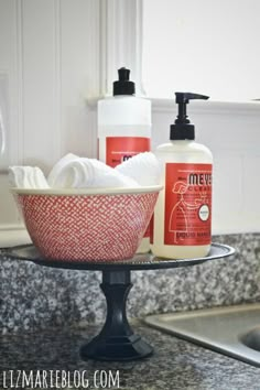 a bathroom sink with soap and lotion on it