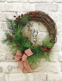 a christmas wreath hanging on a brick wall