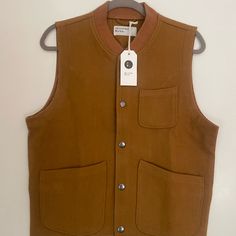 This Is A New, Unworn Universal Works Chore Waistcoat In Medium *I Am 6' Tall And Followed Online Size Guidelines, However The Advised Medium Is Just A Little Too Small* A Uw Classic Gilet; Loose-Fitting Workwear Styling, Yet Sporty And Modern In Feel And Look. Three Patch Pockets With A Button Front And Self Stripe Rib Collar. 'Mowbray' Is A Winter-Ready Melton Cloth With A Dense Wool/Polyamide Weave. Denim Vest Men, Herringbone Vest, Columbia Vest, Panther Print, Golf Vest, Golf Sweaters, 80s Mens, Golf Jackets, Universal Works