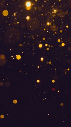 blurry image of yellow and black lights in the night sky with boke effect