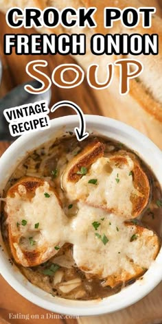 a white bowl filled with french onion soup on top of a wooden cutting board next to bread