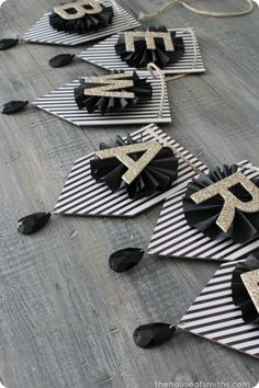 some black and white paper decorations on top of a wooden floor, with the number forty