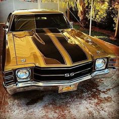 an old muscle car is parked on the street