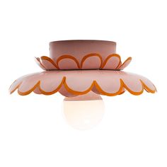 a pink and orange lamp sitting on top of a table