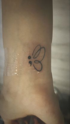 a small tattoo on the ankle of a woman's foot, with an insect