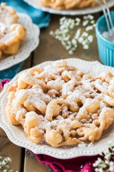 powdered sugar covered cookies on white plates