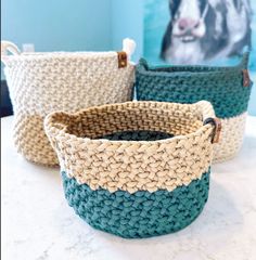 three baskets sitting on top of a white counter next to a blue and green wall