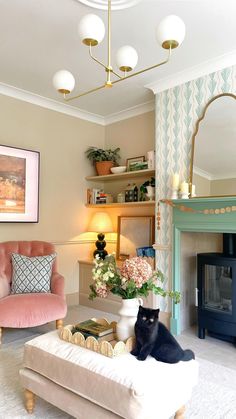 a living room with two cats sitting on the couches in front of a fireplace