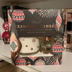 the candle and gift set is in its box on the shelf next to other items