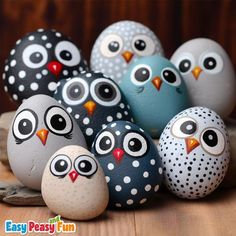 an assortment of painted rock owls sitting on a wooden table with text overlay that says easy peasy fun