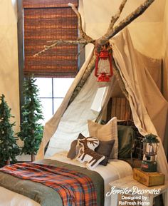 a bedroom with a teepee tent next to a christmas tree