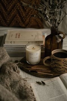 a candle and some books on a table