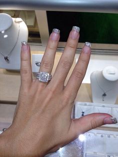 a woman's hand with two rings on it and one ring in the middle