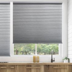 a kitchen window covered in blinds and shades