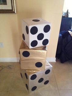 three boxes are stacked on top of each other with black polka dots painted on them