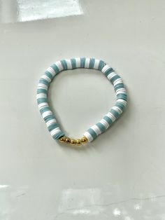 This bracelet is made out of stretchy string and clay beads. It's such a coastal and beachy bracelet, especially for the boardwalk! All orders will recieve 2 stickers and a ring for free. Heishi Beaded Bracelets For Everyday Summer Wear, Everyday Heishi Beads Bracelet For Summer, Trendy Heishi Beads Jewelry For Beach, Everyday Heishi Beads Friendship Bracelets For Summer, White Stackable Friendship Bracelets For Summer, Summer Beach Stackable Jewelry, White Adjustable Stretch Bracelet With Beachy Style, Adjustable White Stretch Bracelet With Beachy Style, Adjustable Coastal Beaded Bracelets For Summer