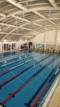 an indoor swimming pool with rows of lanes