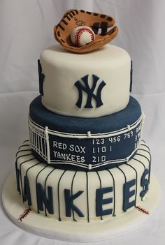 a three tiered cake with baseball and glove on top