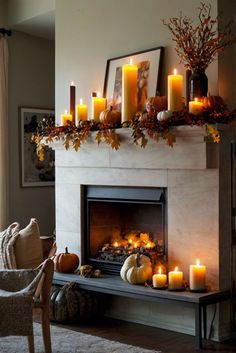 a fireplace with candles and pumpkins on it