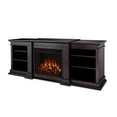 an entertainment center with a fire place and shelves on each side, in black finish