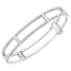 An elegant and modern bangle bracelet with a dusting of sparkling white diamonds along its lateral bars. 18K white gold locking cage bangle bracelet with white diamonds on lateral bars (1.2 tcw) 7.0” internal circumference 0.63” wide Modern Bangle, The Bangles, Bracelet Bangle, White Diamonds, White Gold Diamonds, Bangle Bracelet, Diamond White, Gold Diamond, Bangle Bracelets