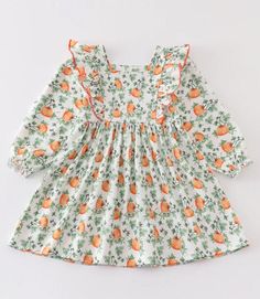 Girls Pumpkin Vine Print Ruffle Dress -100% Cotton -Machine wash/dry on low heat or lay flat to dry Casual Long Sleeve Ruffle Dress For Spring, Orange Cotton Dress For Spring, Green Fruit Print Dresses For Spring, White Cotton Ruffle Dress For Spring, Spring Orange Cotton Dress, Cotton Long Sleeve Dresses For Brunch, Cotton Ruffle Hem Dress For Fall, White Long Sleeve Ruffle Dress For Spring, Fall Cotton Dress With Ruffles