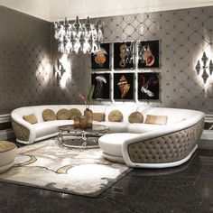 a modern living room with white furniture and chandelier