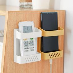 an electronic device attached to a wooden shelf