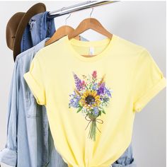 Wildflower Tshirt, Wild Flowers Shirt, Floral Tshirt, Flower Shirt, Gift for Women, Ladies Shirts, Best Friend Gift, Wildflower Tee This unisex t-shirt fits like a well-loved favorite. It has a soft and light feel, with just the right amount of stretch. * Made of combed and ring-spun cotton * Comfortable and flattering for both men and women SIZING * See sizing chart illustration. * If unsure as to what size to order, lay a favorite t-shirt flat and measure from armpit to armpit (width) and top Spring Graphics, Floral Tshirt, Mom Sweater, Botanical Shirt, Cow Shirt, Ladies Shirts, Trendy Clothing, Flower Shirt, Best Friend Gift