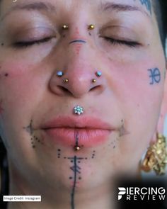 a woman with piercings on her face and nose