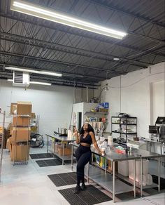 a woman standing in a room with lots of boxes