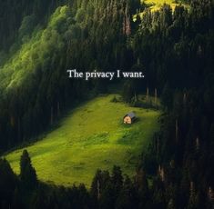 an image of a house in the middle of a field with trees and mountains behind it