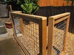 a wooden and wire fence is shown in front of a backyard area with wood chips on the ground