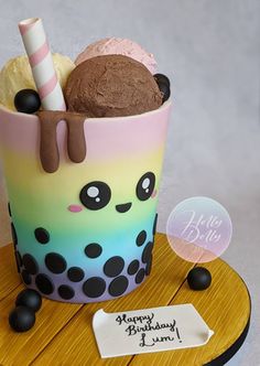 a birthday cake decorated like a cupcake with ice cream and chocolate toppings on top