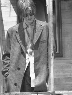 black and white photograph of a man with sunglasses on his face wearing a suit jacket