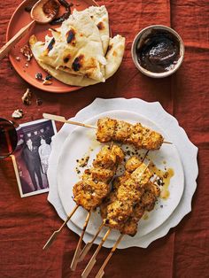 several skewers of food are sitting on a plate