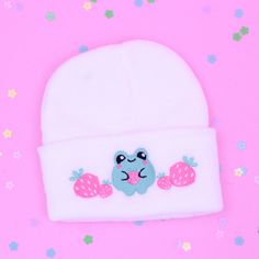 Stay cozy and cute with our Kawaii Strawberry Frog Knit Beanie Hat! This adorable hat features an embroidered strawberry and face, adding a whimsical touch to your winter wardrobe. Made with high-quality knitted fabrics and machine embroidery from a design created and digitized by me, this beanie hat is both stylish and comfortable to wear. Handmade with love in my studio here in the USA, each hat is crafted with attention to detail to ensure its quality. Perfect for chilly days or outdoor adven Cute White Knitted Beanie, Cute Pink Embroidered Hat, Cute Knitted Cap Beanie, Teen Spring Fashion, Strawberry Frog, Embroidered Strawberry, Kawaii Hat, Kawaii Hair Clips, Kawaii Strawberry