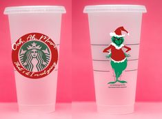 two starbucks cups with the same character on them, one in santa's hat