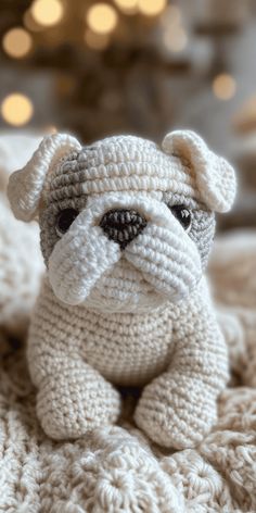 a crocheted stuffed animal sitting on top of a blanket