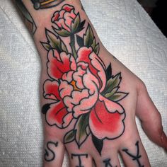 a woman's hand with flowers on it and the words stay strong written in black ink