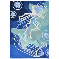 a blue and white rug with an image of a woman in the ocean on it