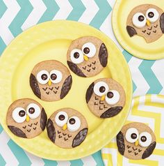 cookies decorated like owls on a yellow plate