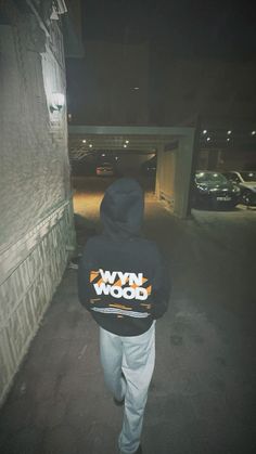 a person in a hoodie walking down the street