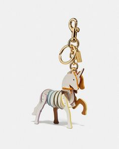 a keychain with a wooden horse on it's front and back ends